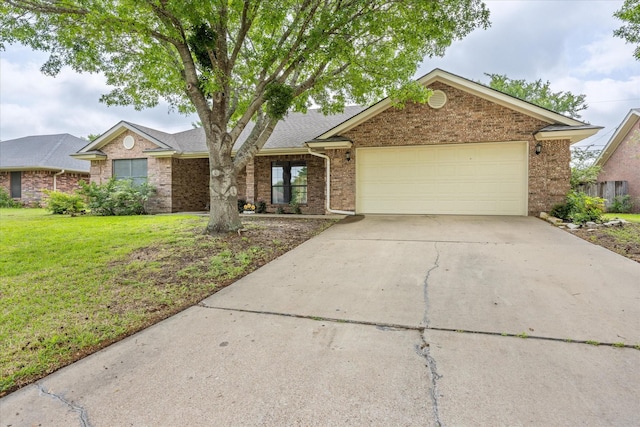 ranch-style home featuring a front lawn, driveway, a garage, and brick siding
