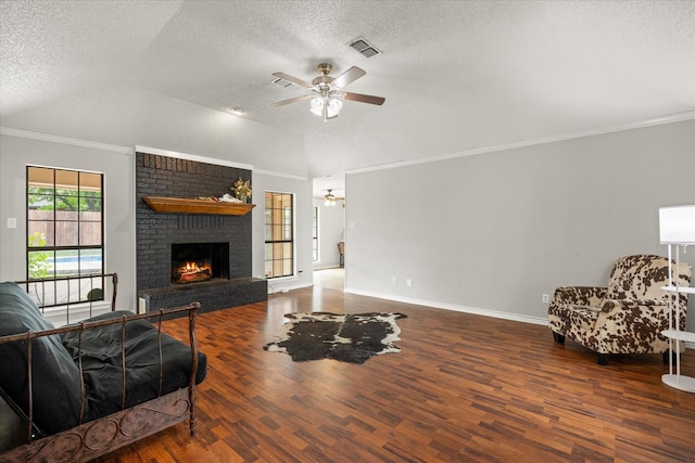 living room featuring wood finished floors, a ceiling fan, and a textured ceiling