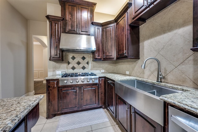 751 Chateaus Dr, Coppell, TX 75019 - kitchen with decorative backsplash, appliances with stainless steel finishes, under cabinet range hood, and light stone countertops