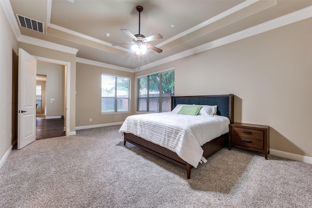 751 Chateaus Dr, Coppell, TX 75019 - carpeted bedroom featuring visible vents, ornamental molding, a raised ceiling, and baseboards