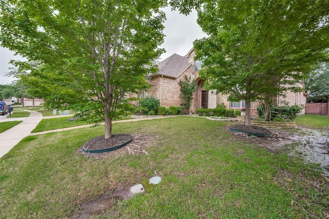 751 Chateaus Dr, Coppell, TX 75019 - view of property hidden behind natural elements with a front lawn and brick siding