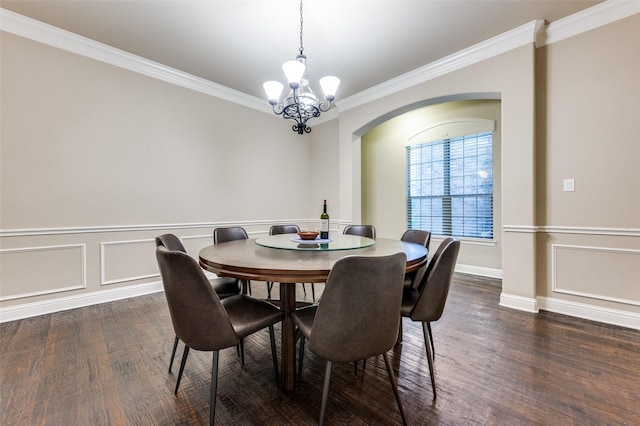 751 Chateaus Dr, Coppell, TX 75019 - dining room featuring dark wood-style flooring, crown molding, arched walkways, wainscoting, and a chandelier