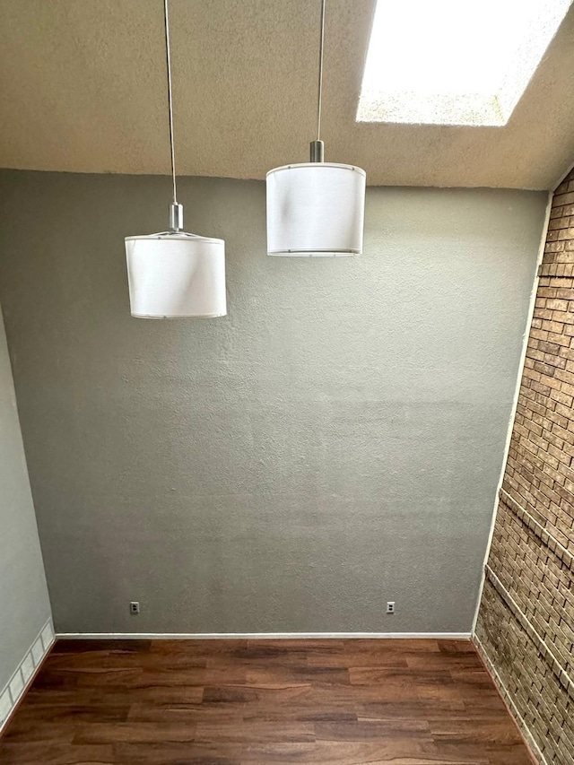interior space with wood finished floors and baseboards
