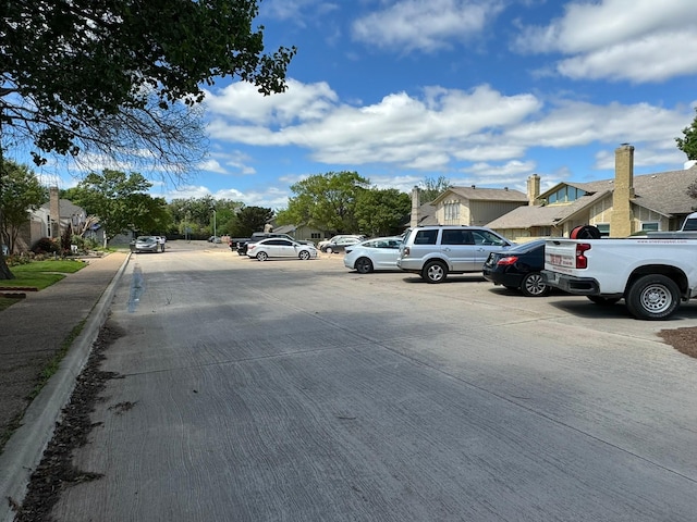 uncovered parking lot featuring a residential view