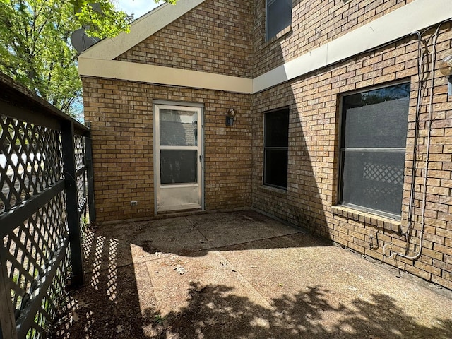 exterior space featuring a patio area and brick siding