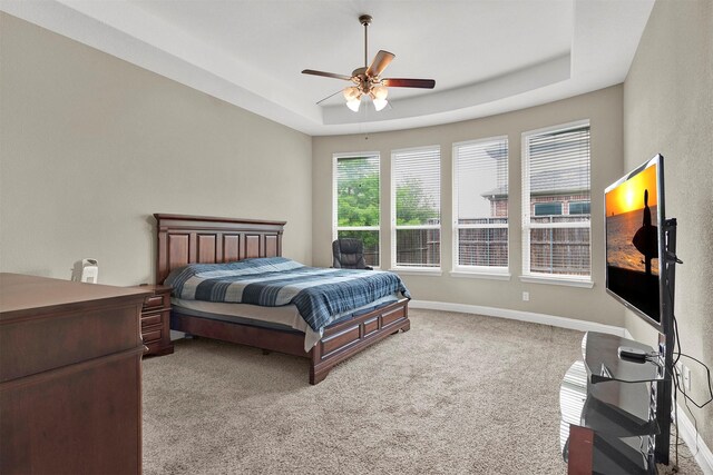 12810 Avanti Dr, Frisco, TX 75035 - bedroom featuring a ceiling fan, baseboards, a tray ceiling, and carpet