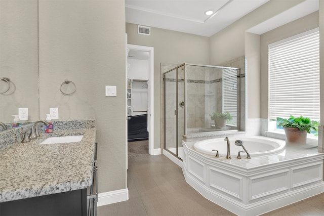 12810 Avanti Dr, Frisco, TX 75035 - full bathroom featuring visible vents, a garden tub, vanity, a spacious closet, and a stall shower