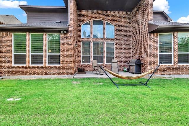 12810 Avanti Dr, Frisco, TX 75035 - rear view of property with brick siding, a patio, and a lawn