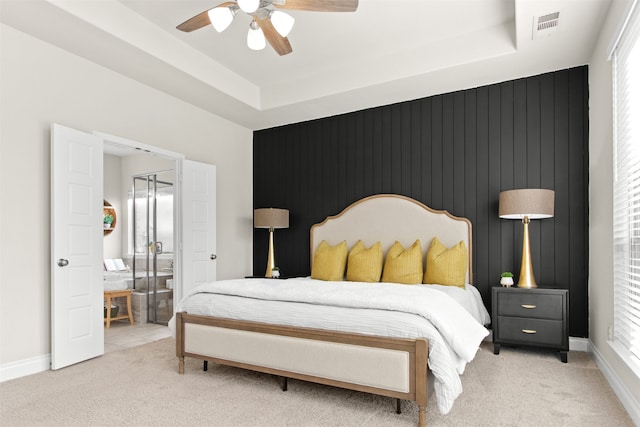 bedroom featuring a raised ceiling, visible vents, baseboards, and carpet floors