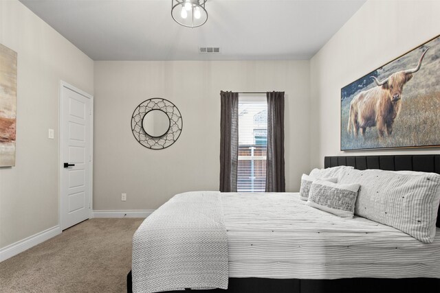 bedroom with carpet, visible vents, and baseboards