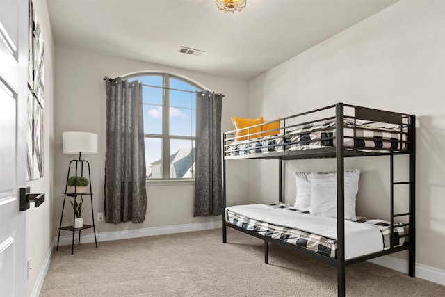 bedroom featuring visible vents, carpet flooring, and baseboards