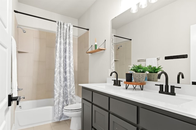 bathroom featuring toilet, tile patterned flooring, a sink, and shower / tub combo with curtain