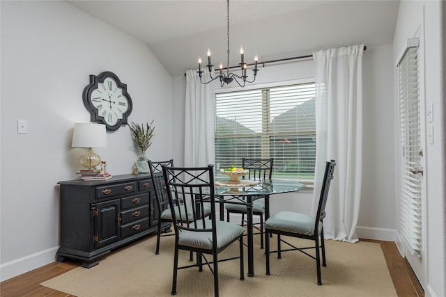 kitchen with a sink, gray cabinets, decorative light fixtures, light wood-style flooring, and appliances with stainless steel finishes