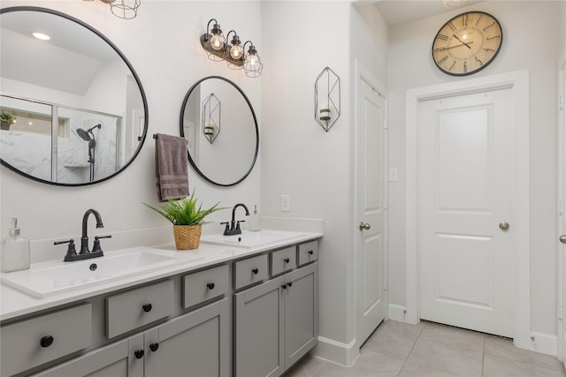 full bath with a sink, double vanity, a stall shower, and tile patterned floors
