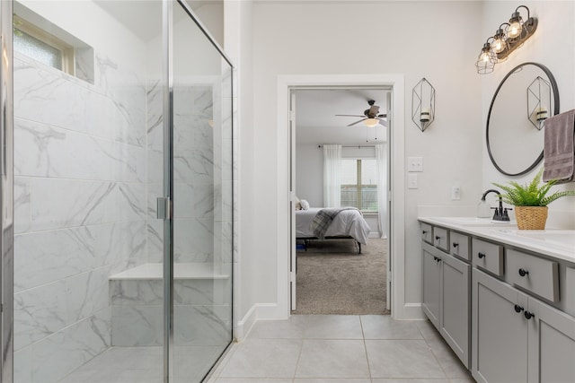 bathroom featuring connected bathroom, a ceiling fan, a stall shower, and a sink