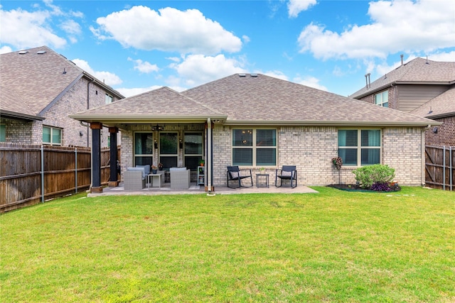 back of property with a patio, a lawn, and a fenced backyard