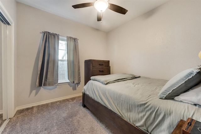 bedroom with baseboards, ceiling fan, a closet, and carpet flooring