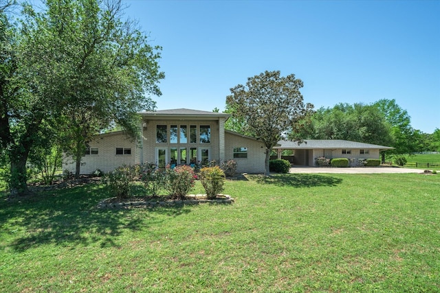 view of yard with concrete driveway and an attached carport
