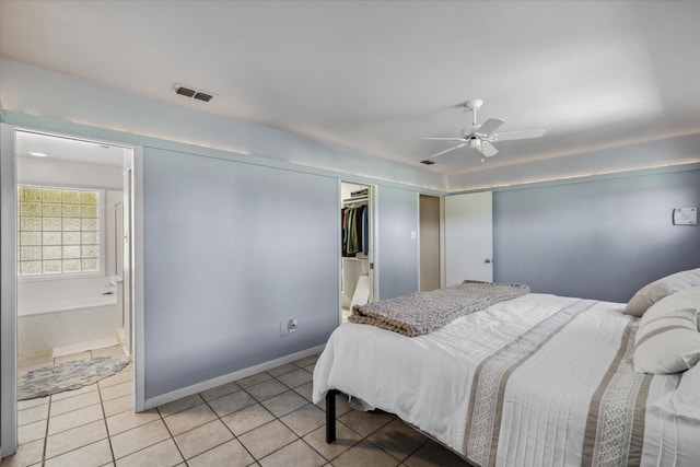 bedroom with light tile patterned floors, a closet, visible vents, and ceiling fan