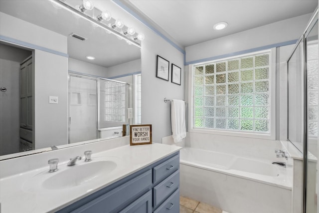 full bath featuring a shower stall, vanity, visible vents, a garden tub, and tile patterned flooring