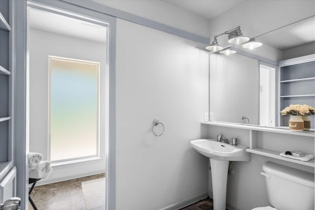 bathroom featuring toilet and a sink