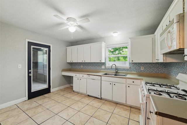 kitchen featuring ceiling fan, backsplash, a sink, white appliances, and white cabinetry