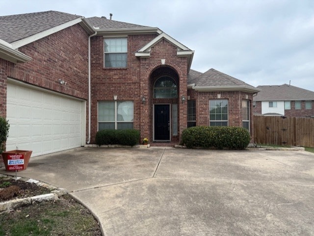 3609 S Texas Dr, Sachse, TX 75048 - traditional-style home with roof with shingles, fence, concrete driveway, and brick siding