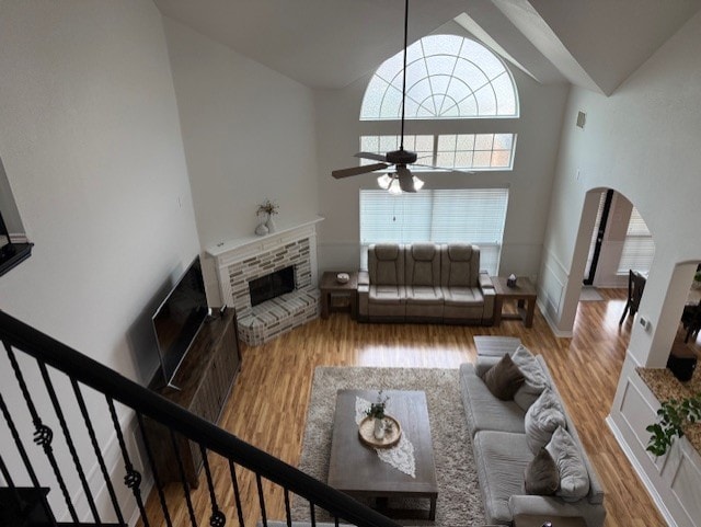 3609 S Texas Dr, Sachse, TX 75048 - living room with a brick fireplace, wood finished floors, high vaulted ceiling, and ceiling fan