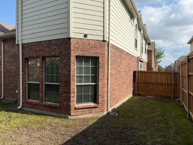 3609 S Texas Dr, Sachse, TX 75048 - view of property exterior with brick siding, fence, and a yard