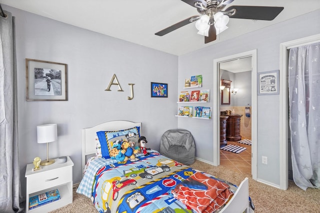 bedroom featuring baseboards, ensuite bathroom, ceiling fan, and carpet flooring