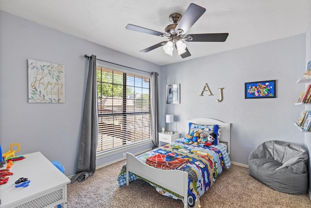 carpeted bedroom with a ceiling fan and baseboards
