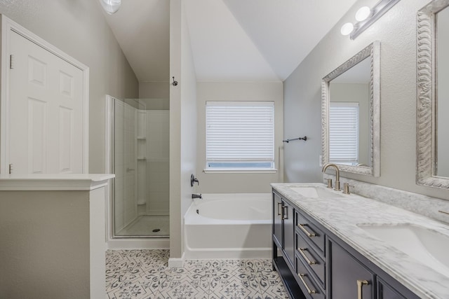 full bathroom with a wealth of natural light, a bath, a stall shower, and a sink