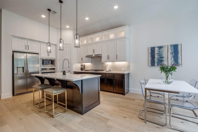 1823 Bell Ct, Van Alstyne, TX 75495 - kitchen with appliances with stainless steel finishes, light wood finished floors, light countertops, white cabinetry, and recessed lighting