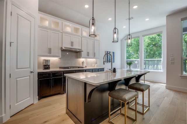 1823 Bell Ct, Van Alstyne, TX 75495 - kitchen with stainless steel gas stovetop, light wood finished floors, light countertops, backsplash, and recessed lighting