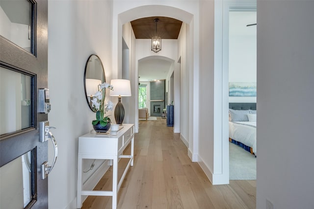 1823 Bell Ct, Van Alstyne, TX 75495 - hallway with arched walkways and light wood-type flooring