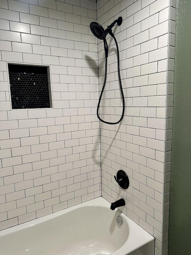 full bathroom featuring shower / tub combination and a textured wall