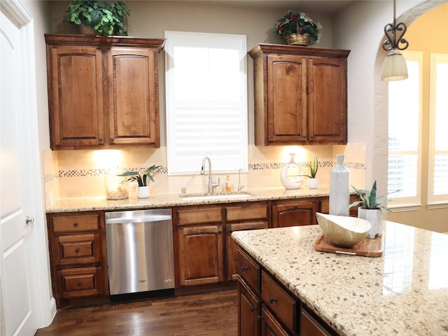 1852 Audubon Pond Way, Allen, TX 75013 - kitchen with dishwasher, dark wood finished floors, light stone counters, hanging light fixtures, and brown cabinetry