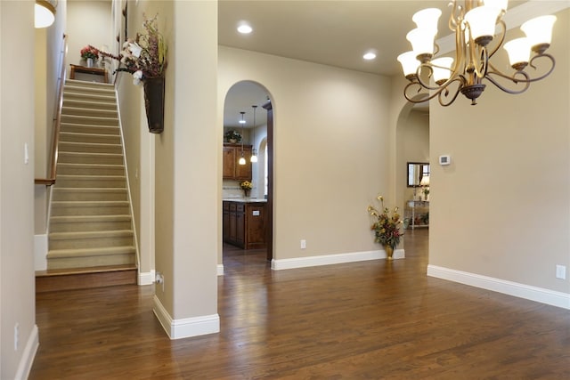1852 Audubon Pond Way, Allen, TX 75013 - entrance foyer with arched walkways, dark wood finished floors, stairs, a chandelier, and recessed lighting