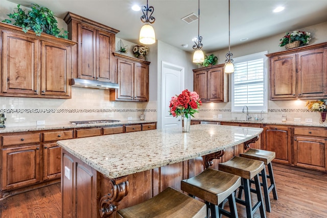 1852 Audubon Pond Way, Allen, TX 75013 - kitchen with decorative backsplash, dark wood-style flooring, a center island, a sink, and under cabinet range hood