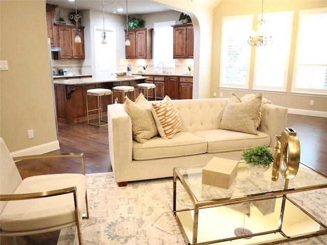 1852 Audubon Pond Way, Allen, TX 75013 - living room with wood finished floors, a chandelier, arched walkways, and recessed lighting