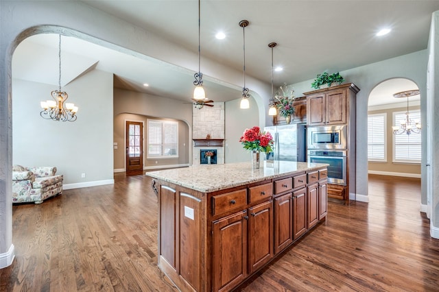 1852 Audubon Pond Way, Allen, TX 75013 - kitchen featuring an inviting chandelier, arched walkways, dark wood-style floors, and stainless steel appliances