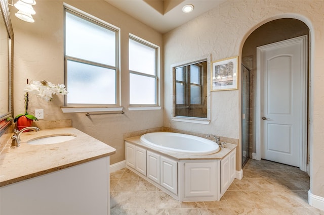 1852 Audubon Pond Way, Allen, TX 75013 - bathroom featuring a garden tub, tile patterned flooring, a shower stall, vanity, and a textured wall