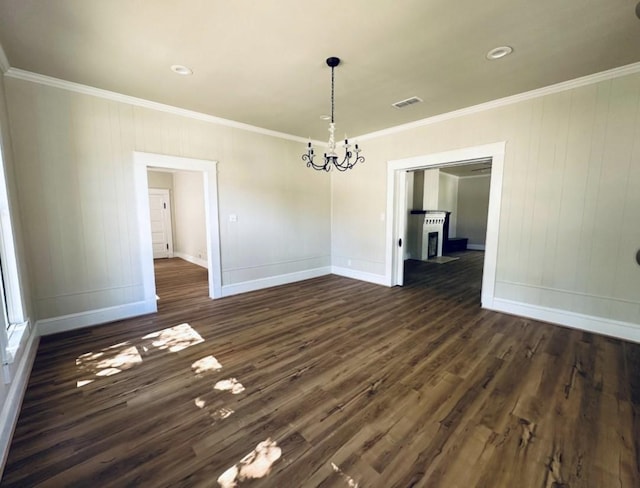 unfurnished dining area with ornamental molding, dark wood-style floors, and baseboards