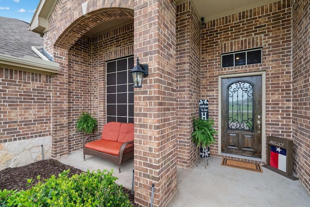 property entrance featuring brick siding