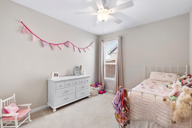 bedroom featuring baseboards, ceiling fan, and light colored carpet