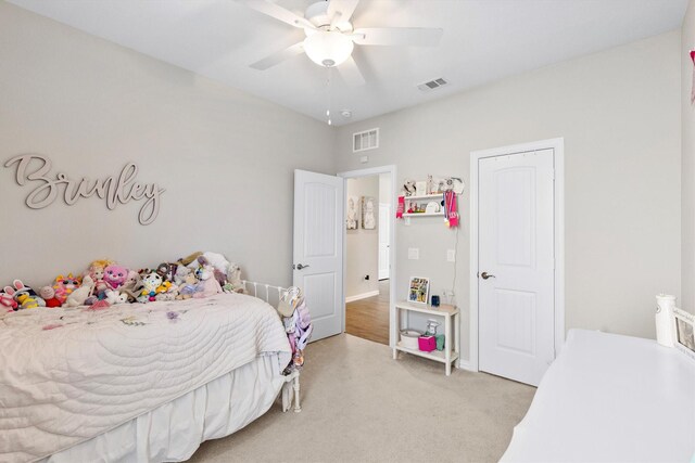 bedroom with light colored carpet, visible vents, ceiling fan, and baseboards