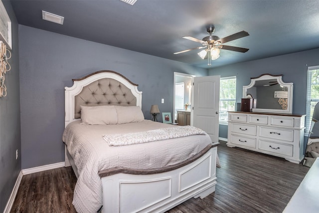 bedroom featuring multiple windows, ceiling fan, dark wood finished floors, and baseboards