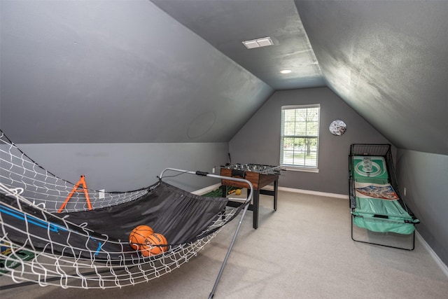 playroom with visible vents, vaulted ceiling, carpet, and baseboards
