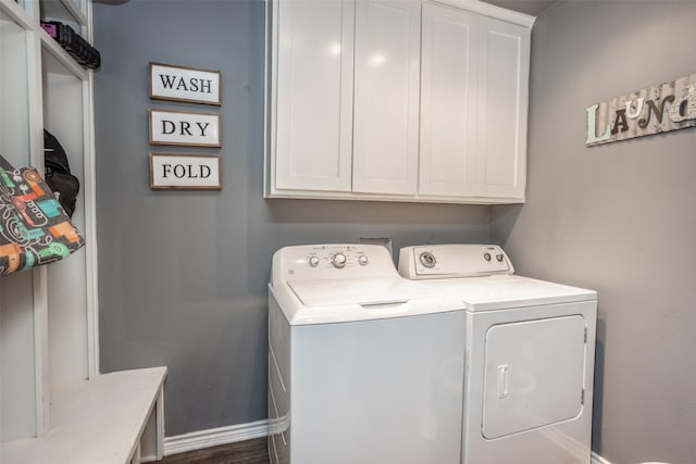 washroom with cabinet space and washing machine and dryer