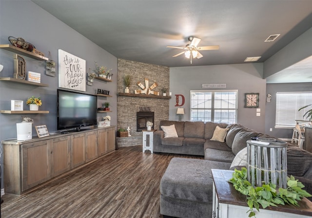 living room featuring a fireplace, dark wood-style floors, ceiling fan, and visible vents